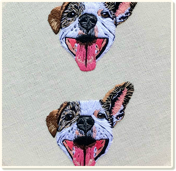Two embroidered dogs on a cloth.